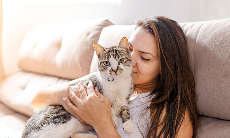 A woman cuddling her cat