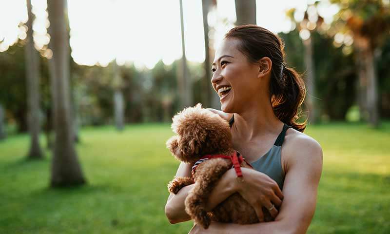 A woman holding her dog