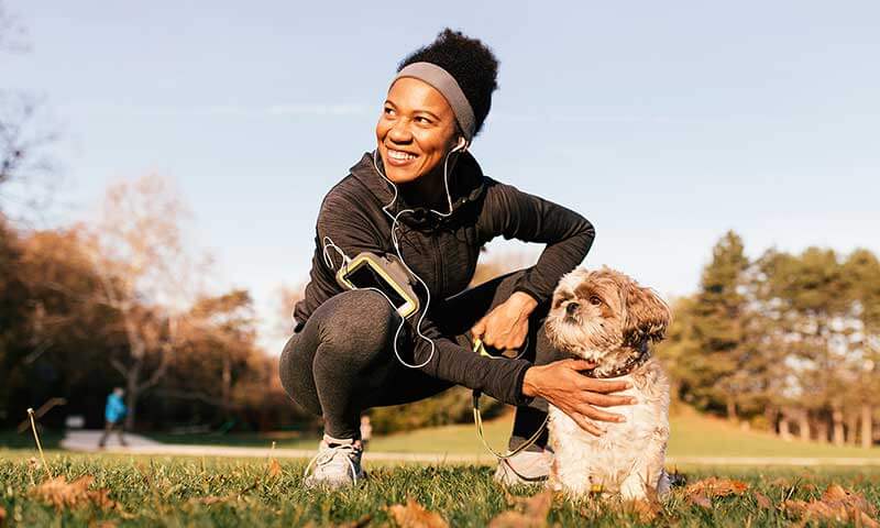 A woman out for a run with her dog