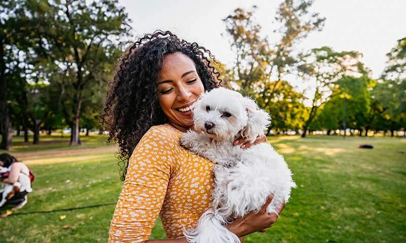 A woman with her dog outside